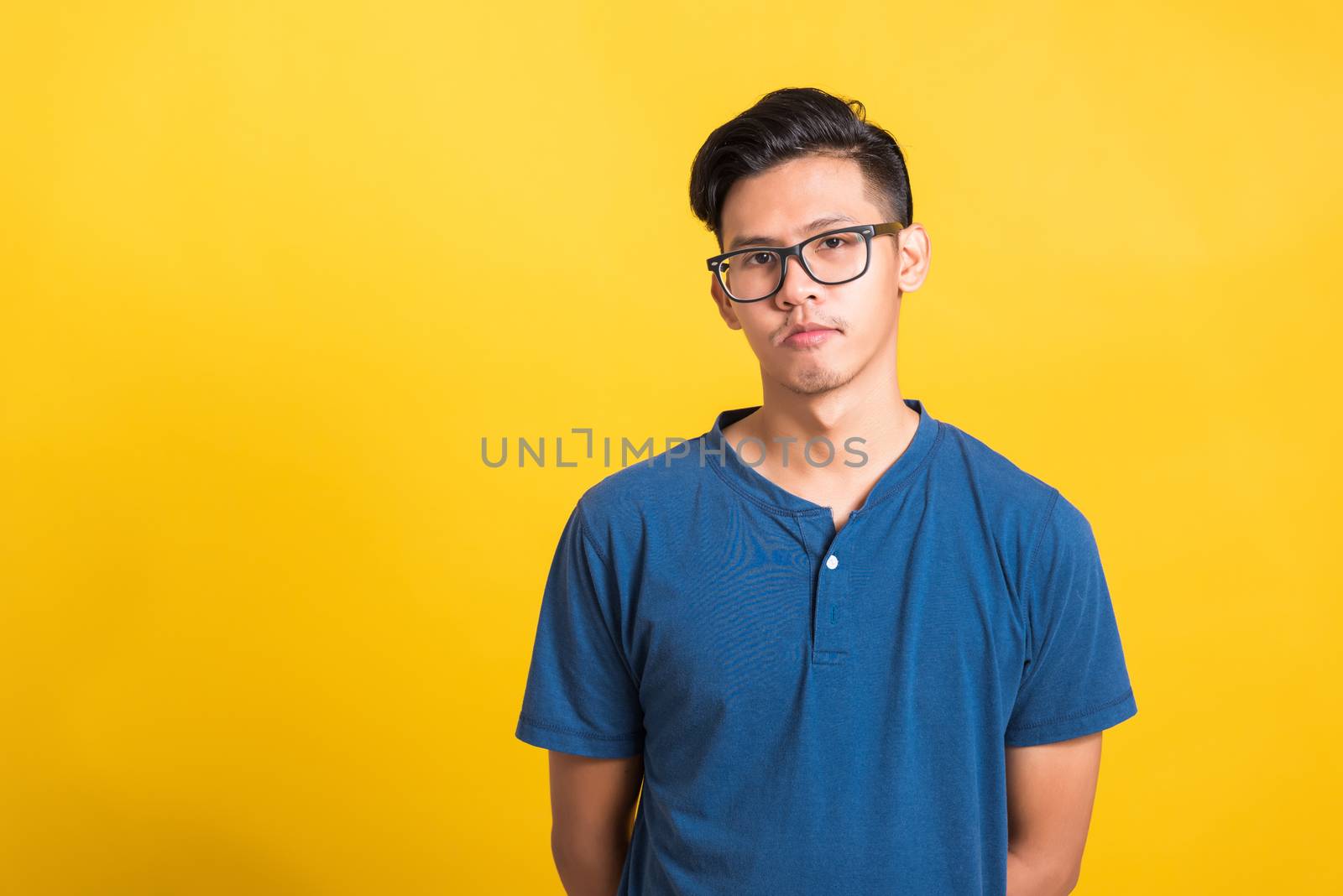 Headshot portrait of Asian young handsome man wear eyeglasses or spectacles, studio short isolated on yellow background with copy space, Fashion male beauty concept