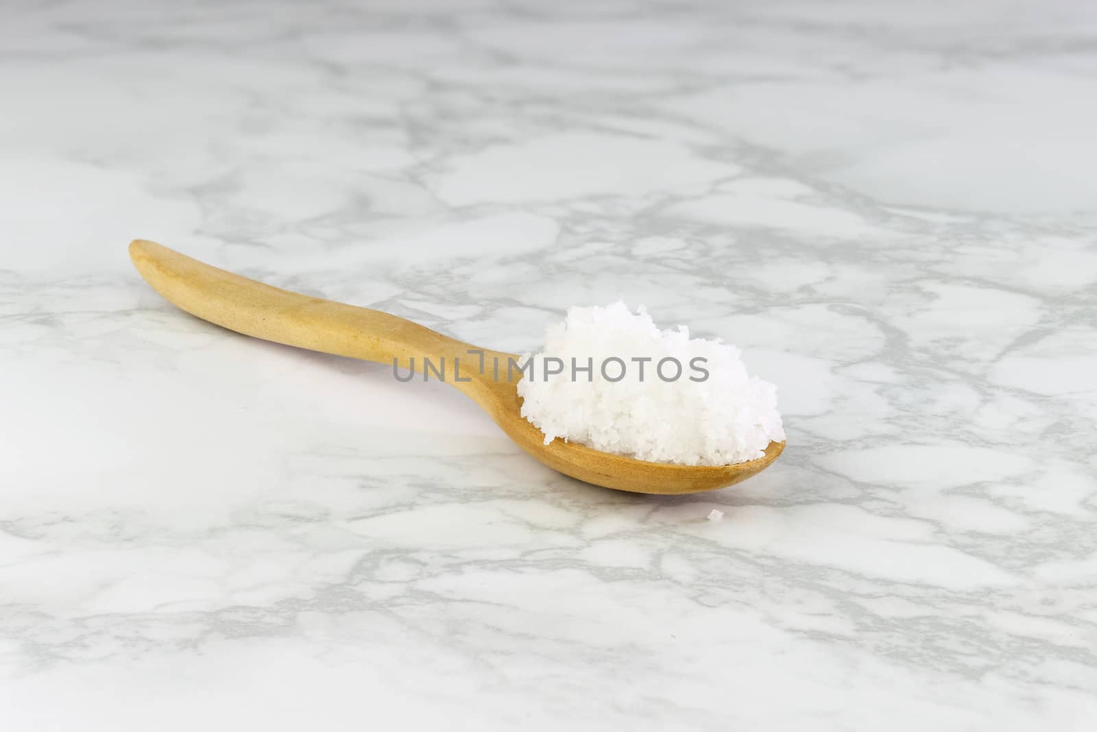 sea salt in wooden spoon on Cement Tiles