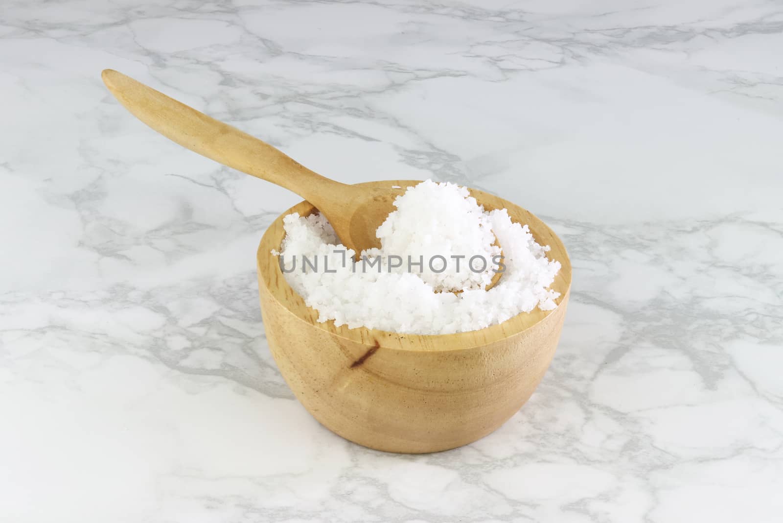 sea salt in wooden bowl and wooden spoon on Cement Tiles