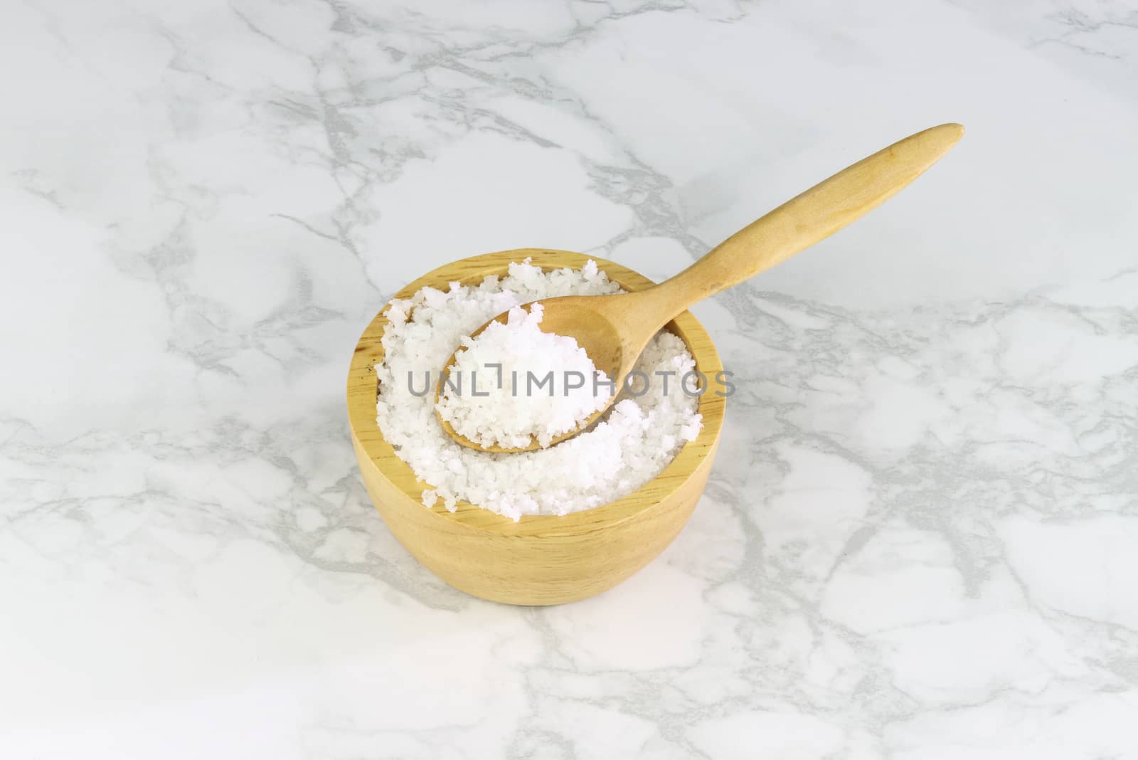 sea salt in wooden bowl and wooden spoon on Cement Tiles