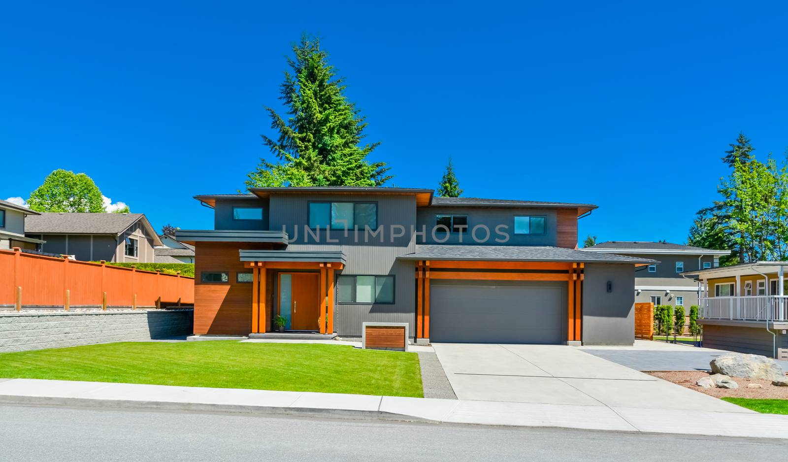 Newly renovated family house in Vancouver, British Columbia. Residential house with wide garage door and concrete driveway