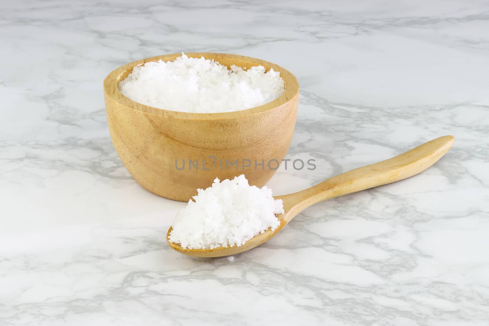 sea salt in wooden bowl and wooden spoon on Cement Tiles