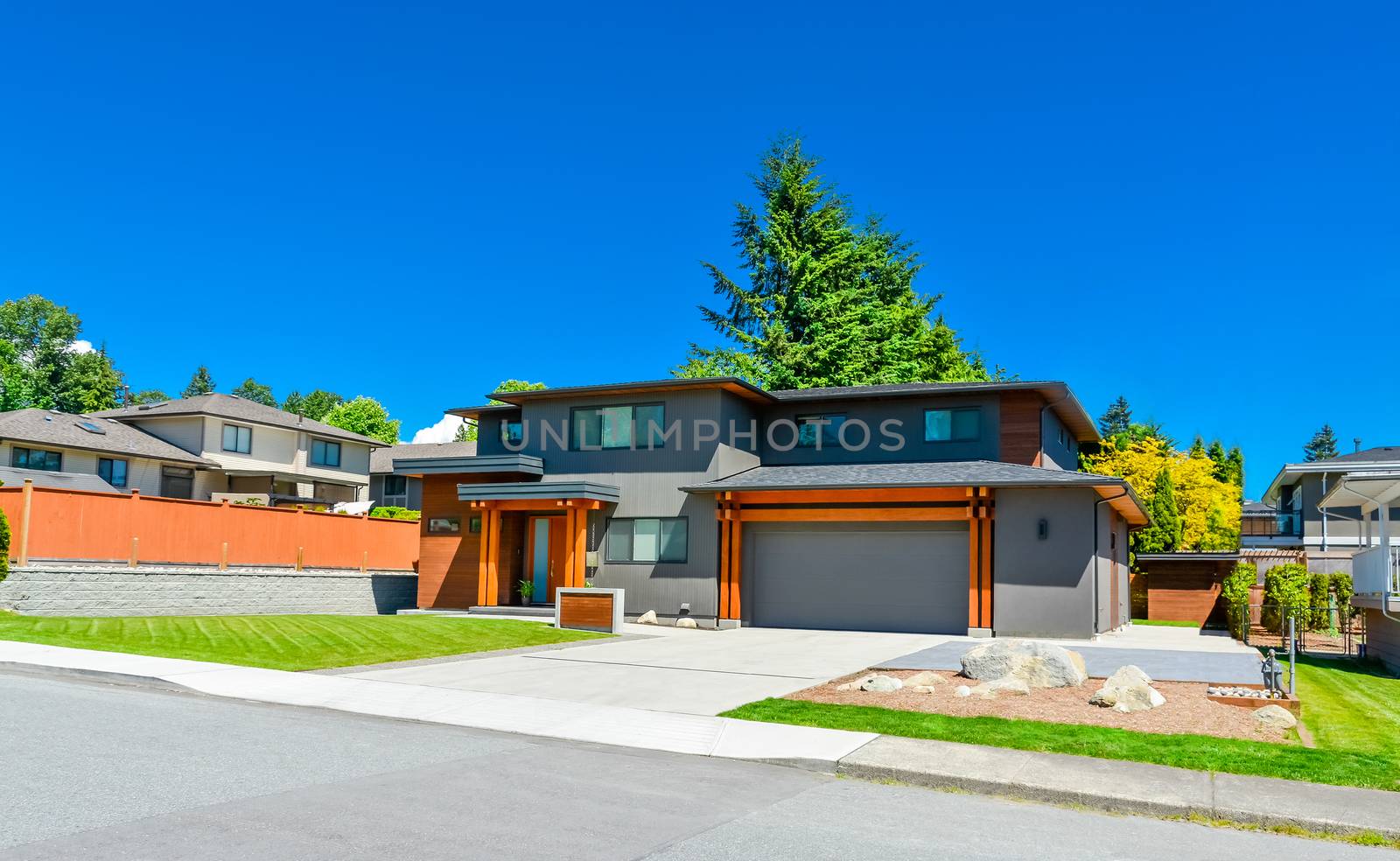 Newly renovated family house in Vancouver, British Columbia. Residential house with wide garage door and concrete driveway