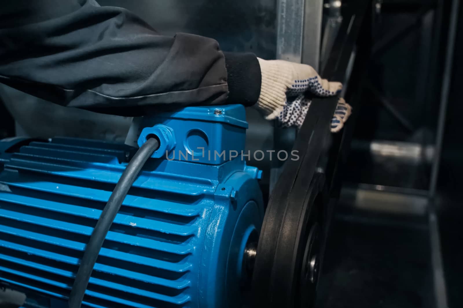 A force test of the electric motor's drive belt.