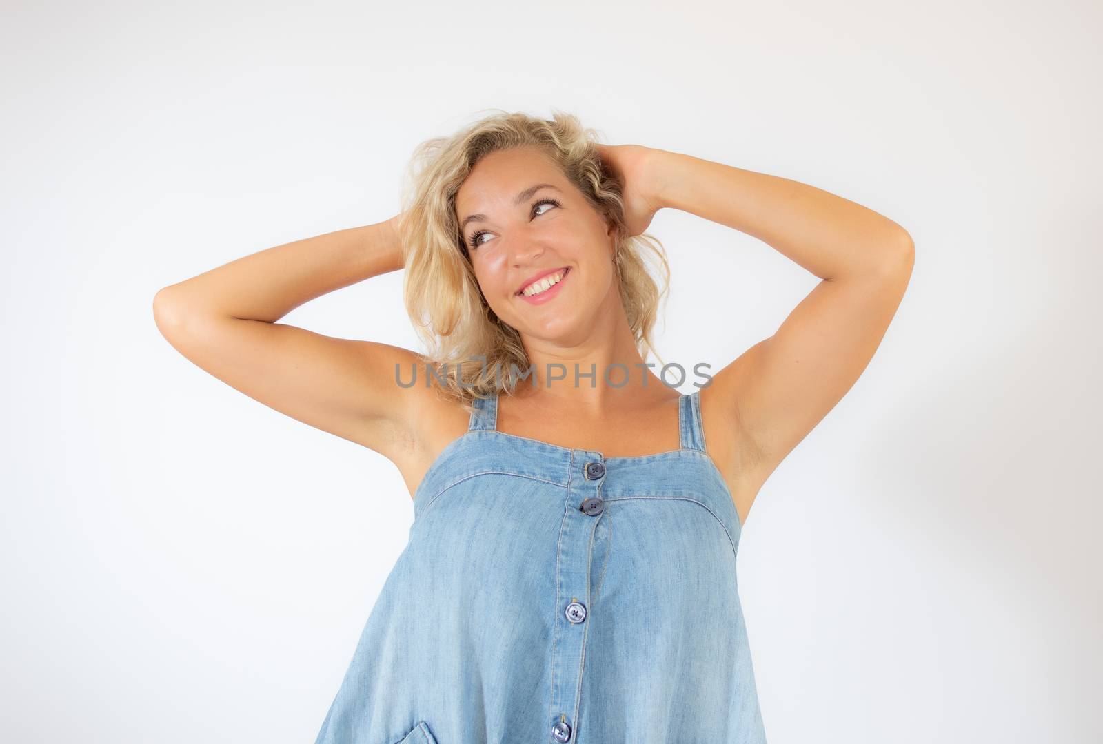 Pretty blonde woman in blue dress smiling