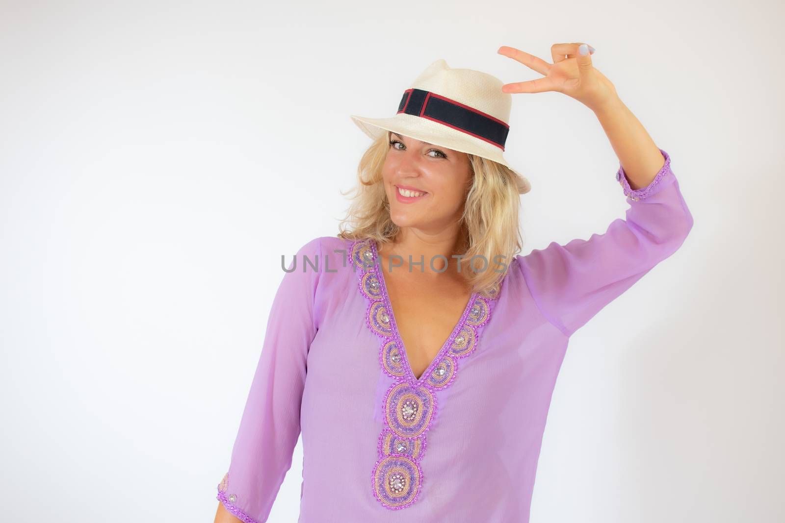 Pretty blonde woman wearing sunglasses and with a lilac caftan