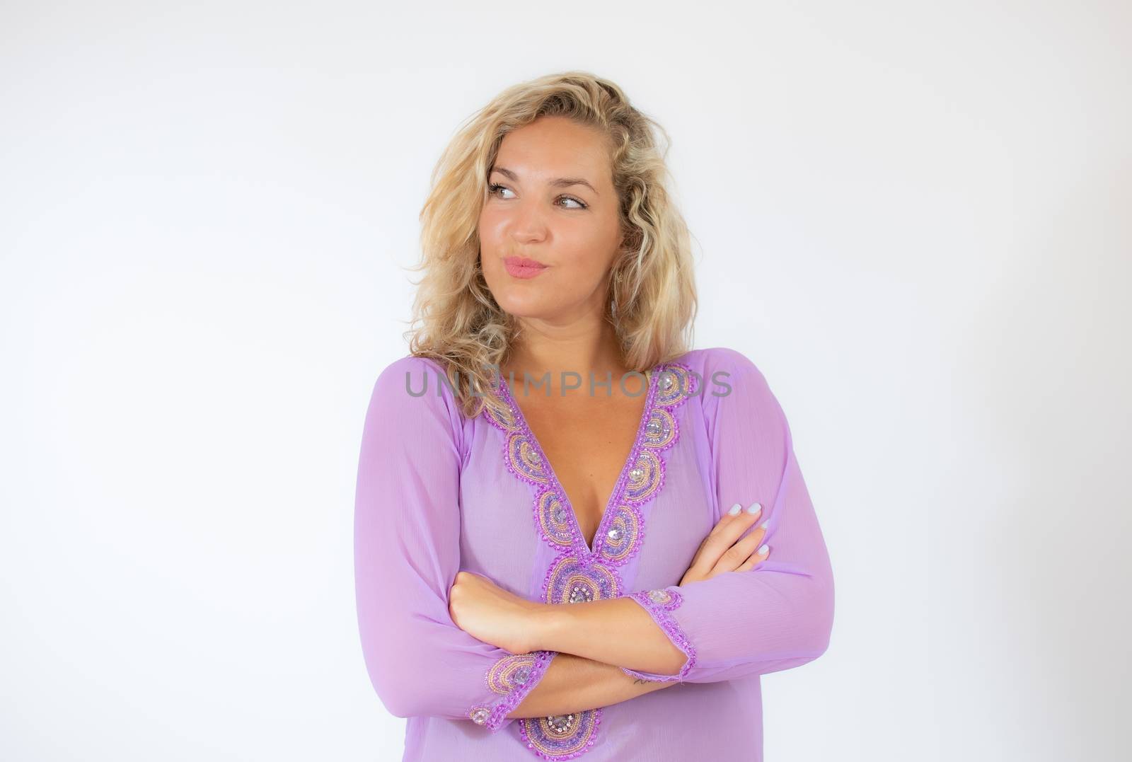 Pretty blonde woman in lila caftan smiling on white background