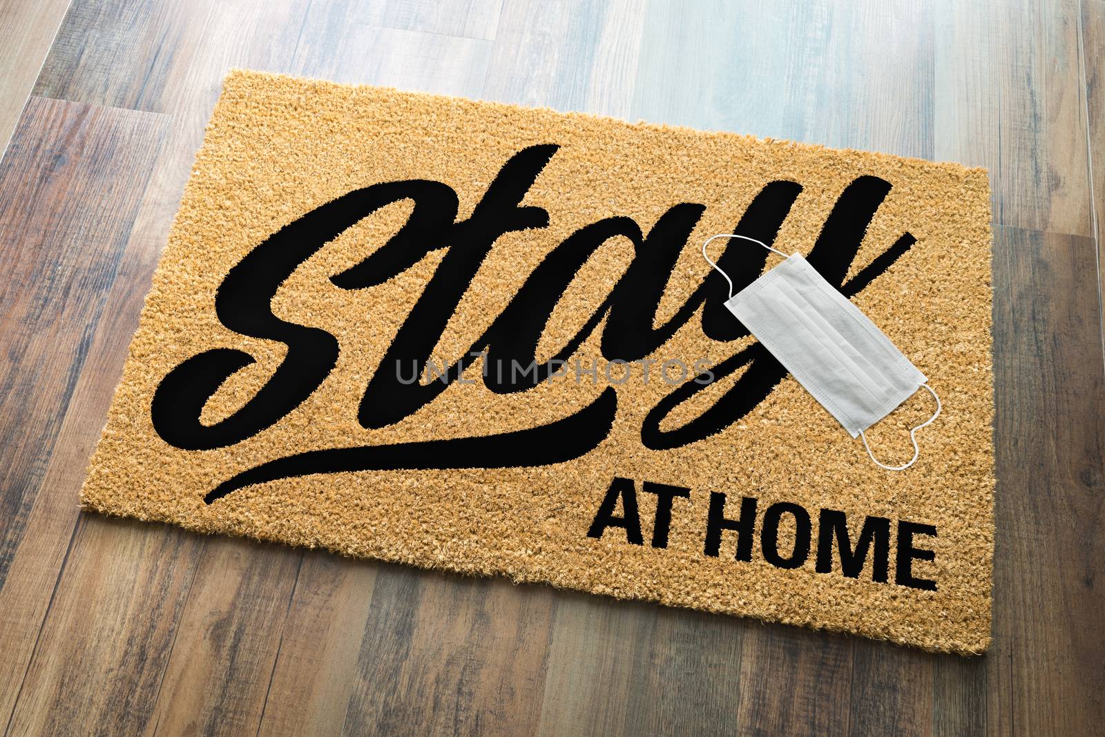 Stay At Home Welcome Mat with Medical Face Face Resting On Floor.