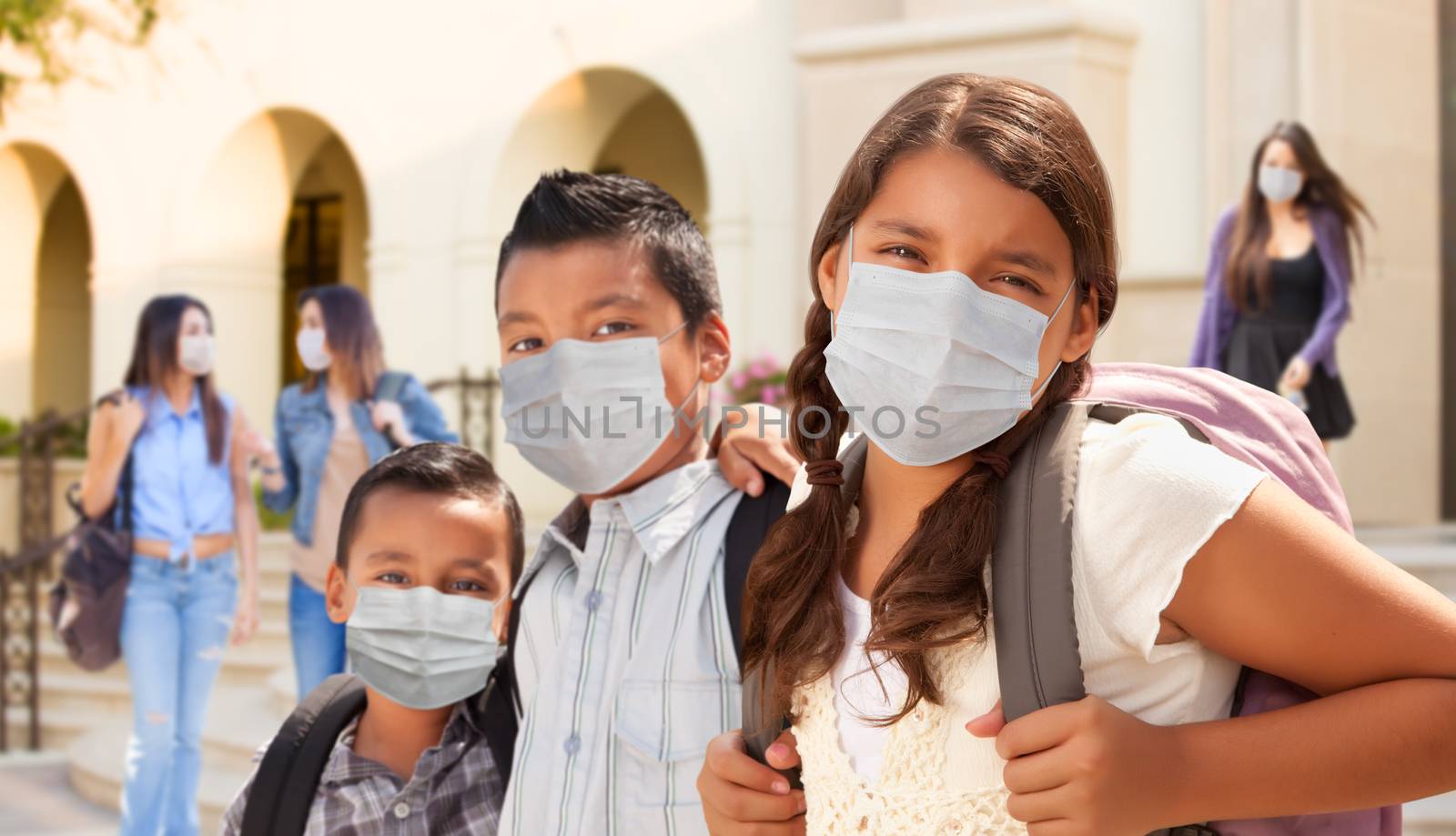 Young Students on School Campus Wearing Medical Face Masks by Feverpitched