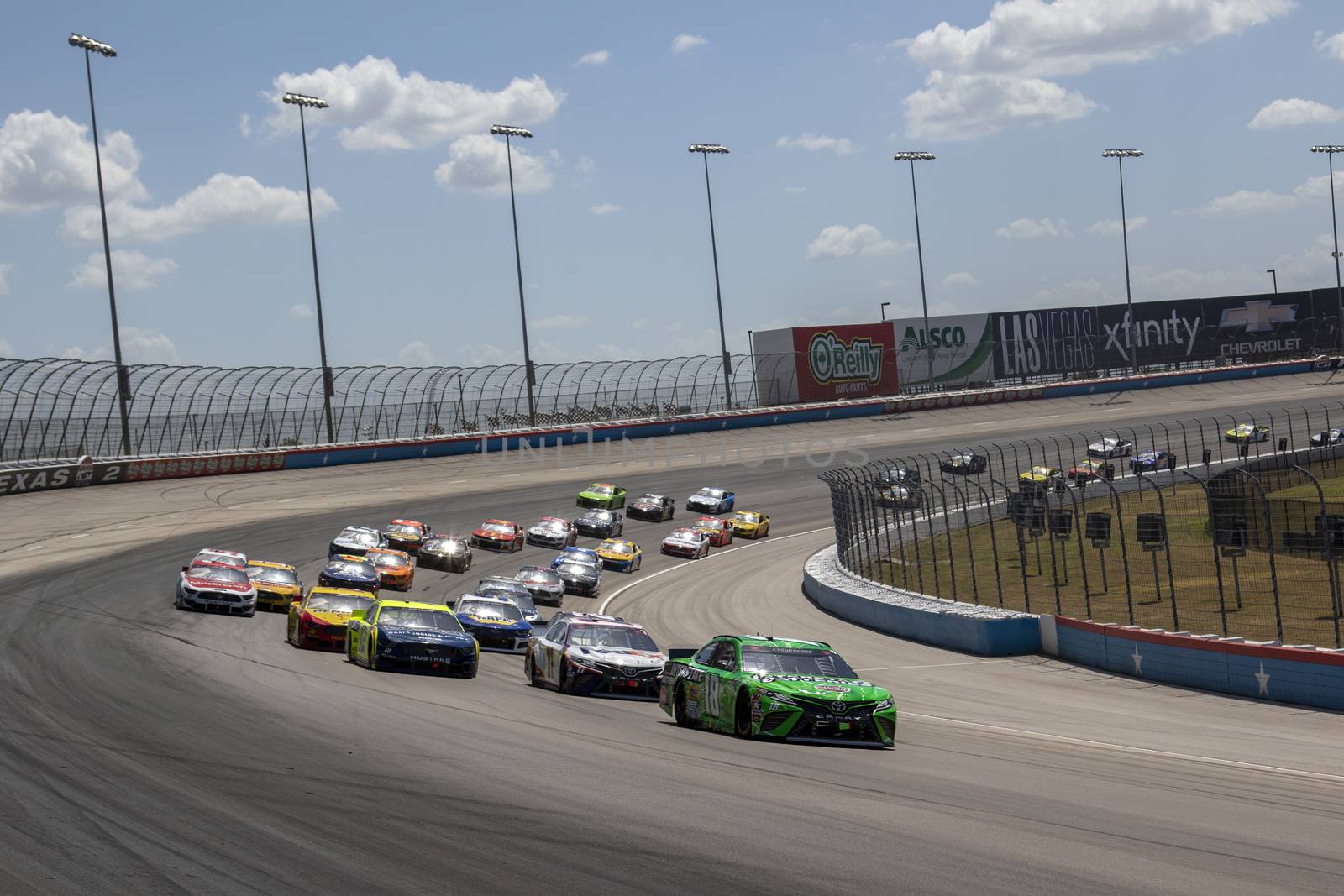 Kyle Busch (18) races for position the O'Reilly Auto Parts 500 at Texas Motor Speedway in Fort Worth, Texas.