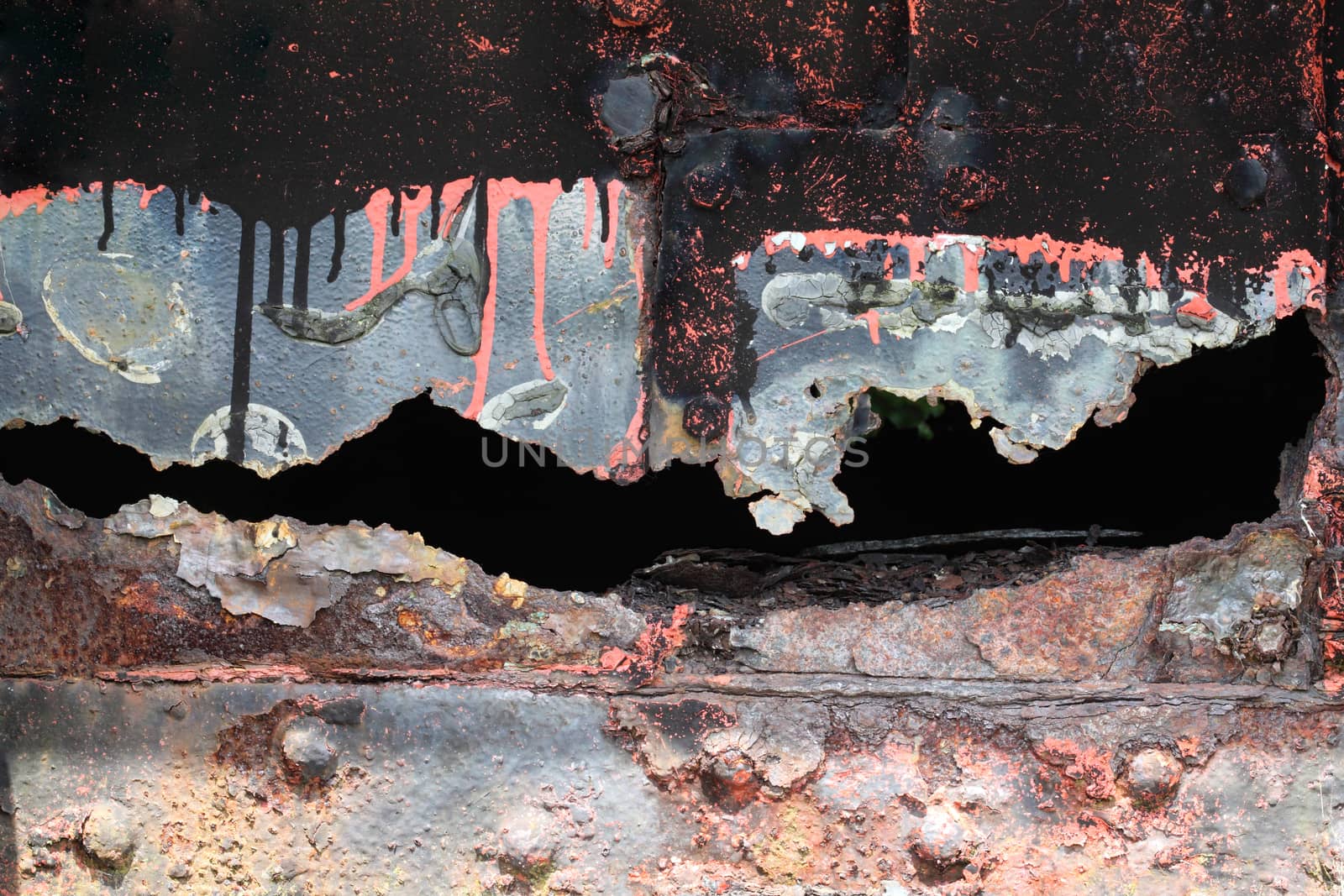 Background texture of an old distressed cracked iron panel covered in rust