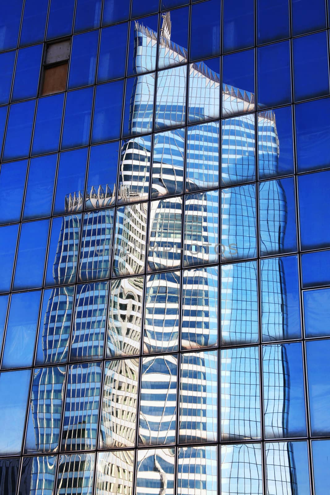 Reflection of a skyscraper office block in glass windows