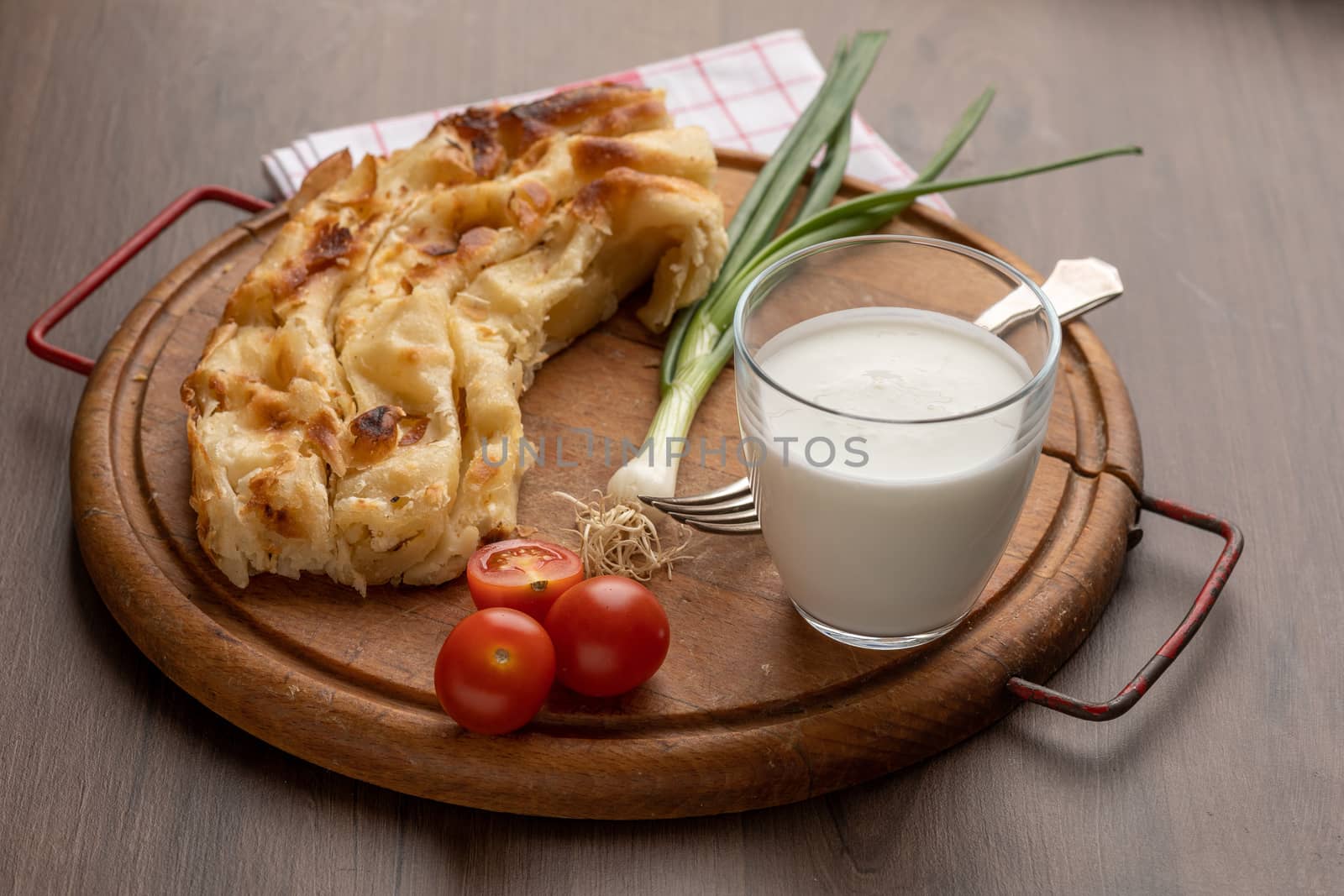 Traditional balkan breakfast - Borek or Burek pie with cheese aranged on wooden table