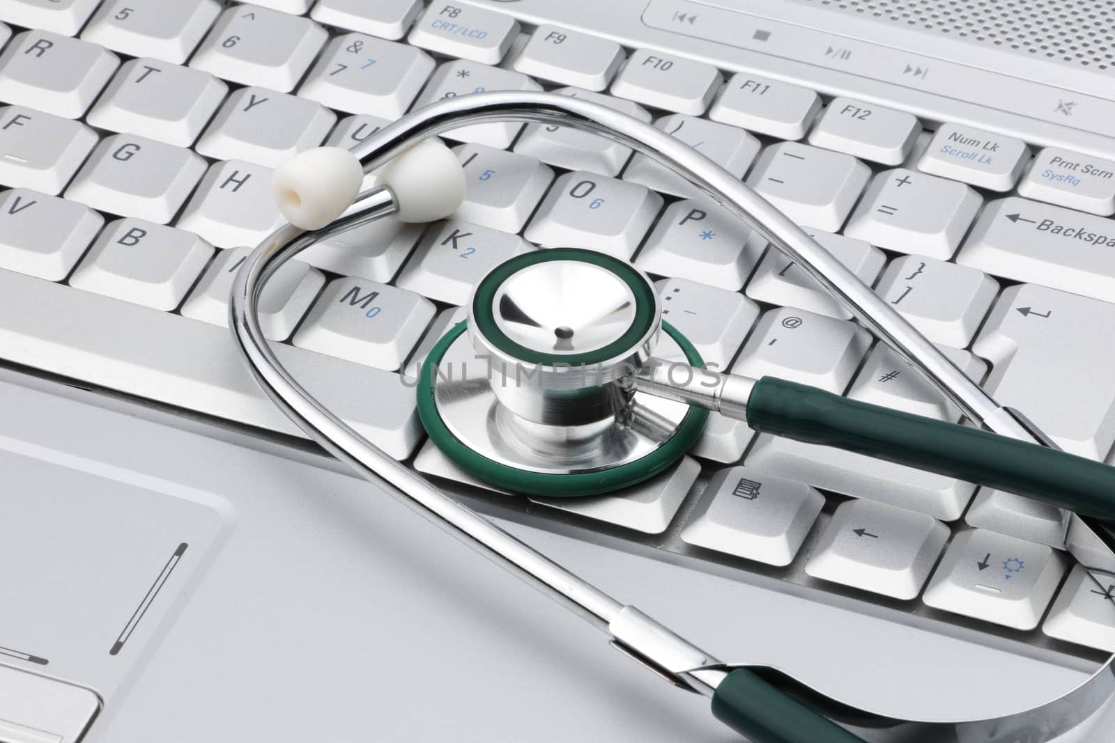 A medical stethoscope on a laptop signifying the relationship of IT and medicine