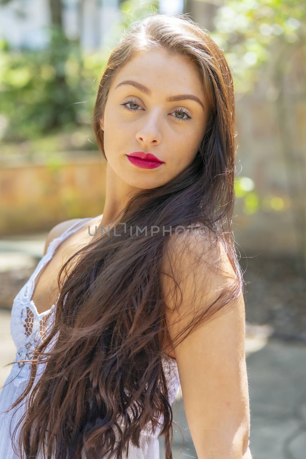 A gorgeous brunette model enjoys a spring day outdoors