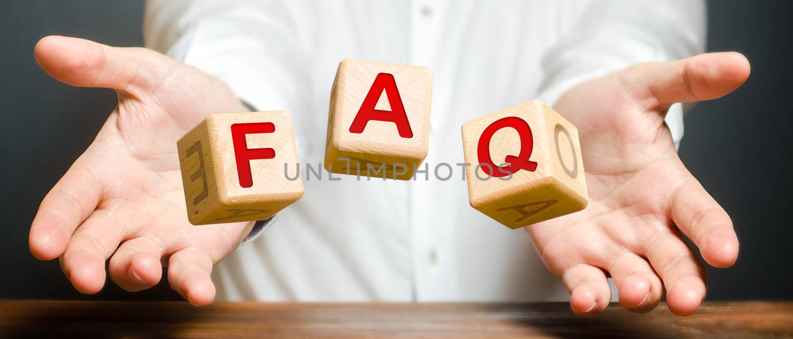 Cubes thrown by a man make word abbreviation acronym FAQ (frequently asked questions). Instructions and rules. Avoid frequent errors. Convenient form of answers explanations for users and customers.