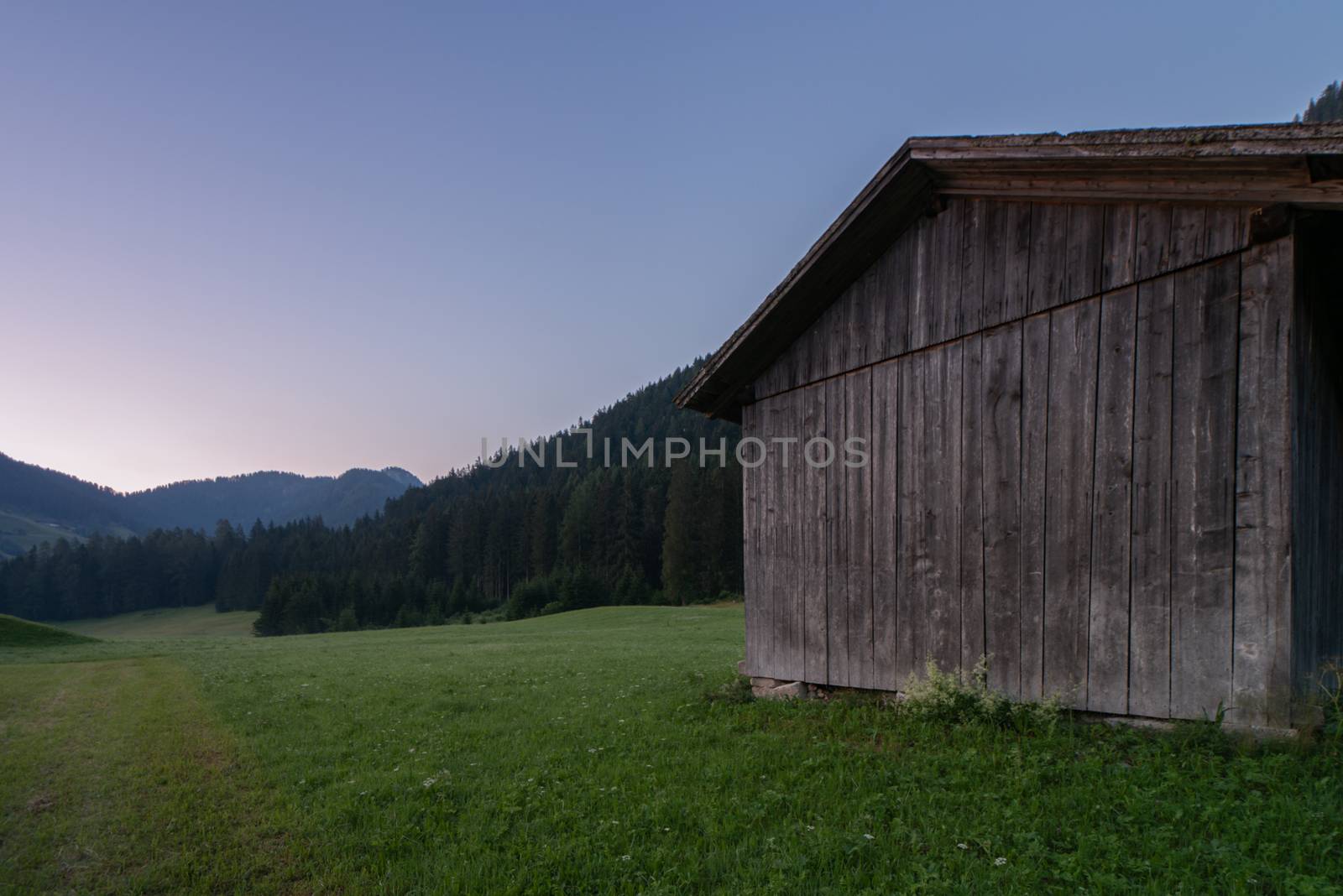 Wooden shed immersed in the mountain landscape of the Val Pusteria in the Dolomites of South Tyrol