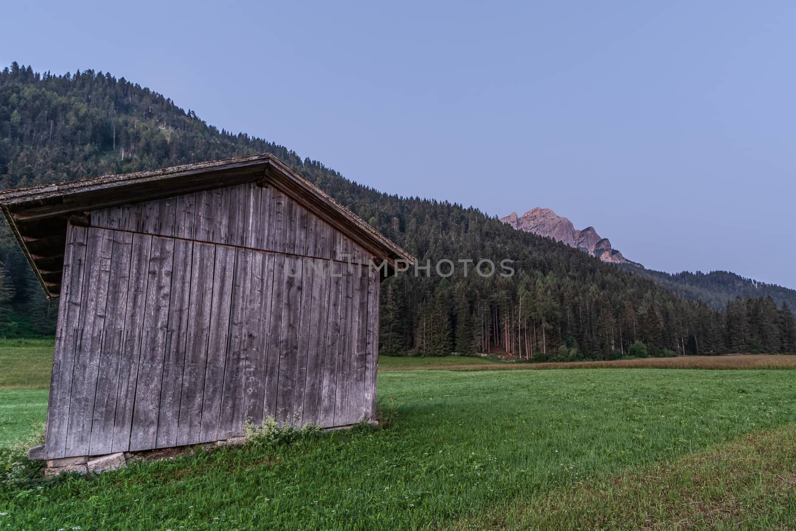 Wooden shed immersed in the mountain landscape of the Val Pusteria in the Dolomites of South Tyrol