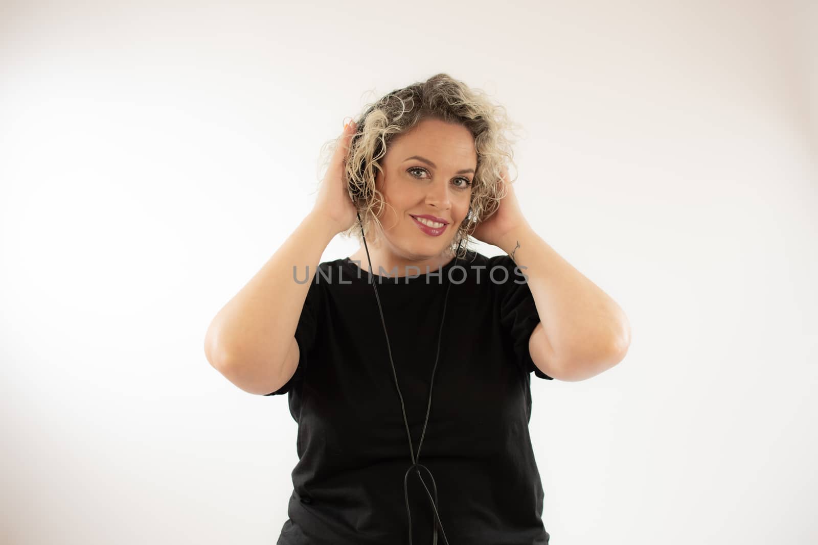 Blonde young woman smiling with headphones