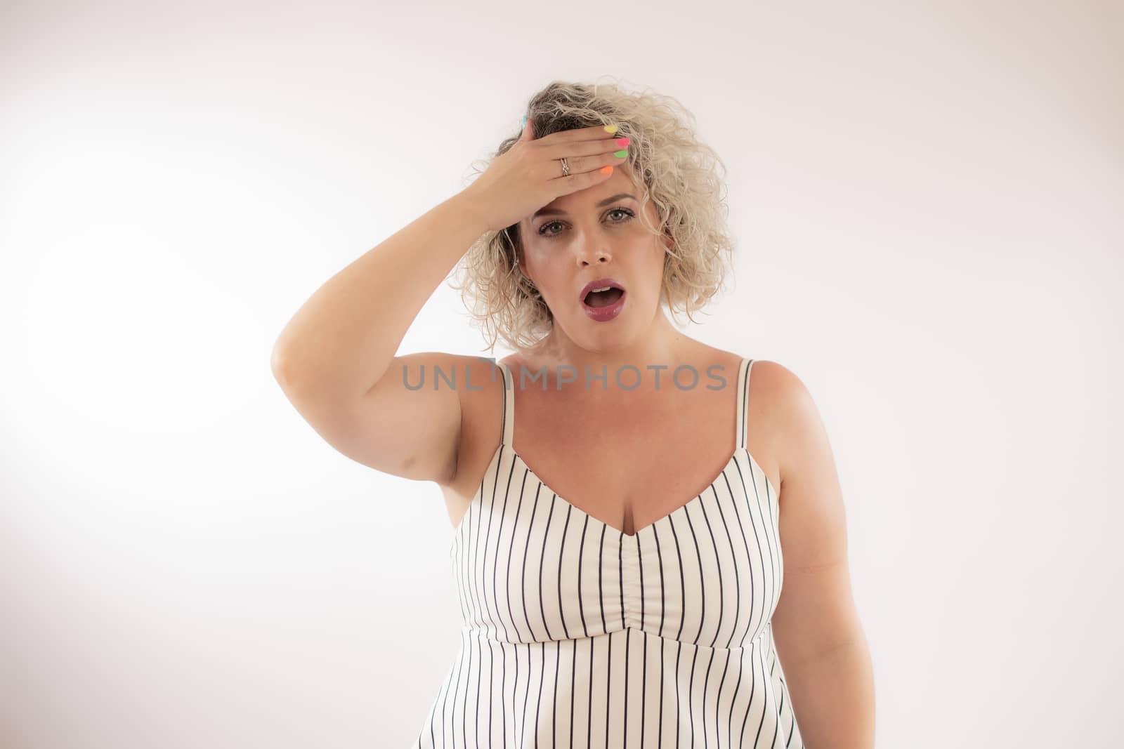 Blonde young woman with the gesture of headache