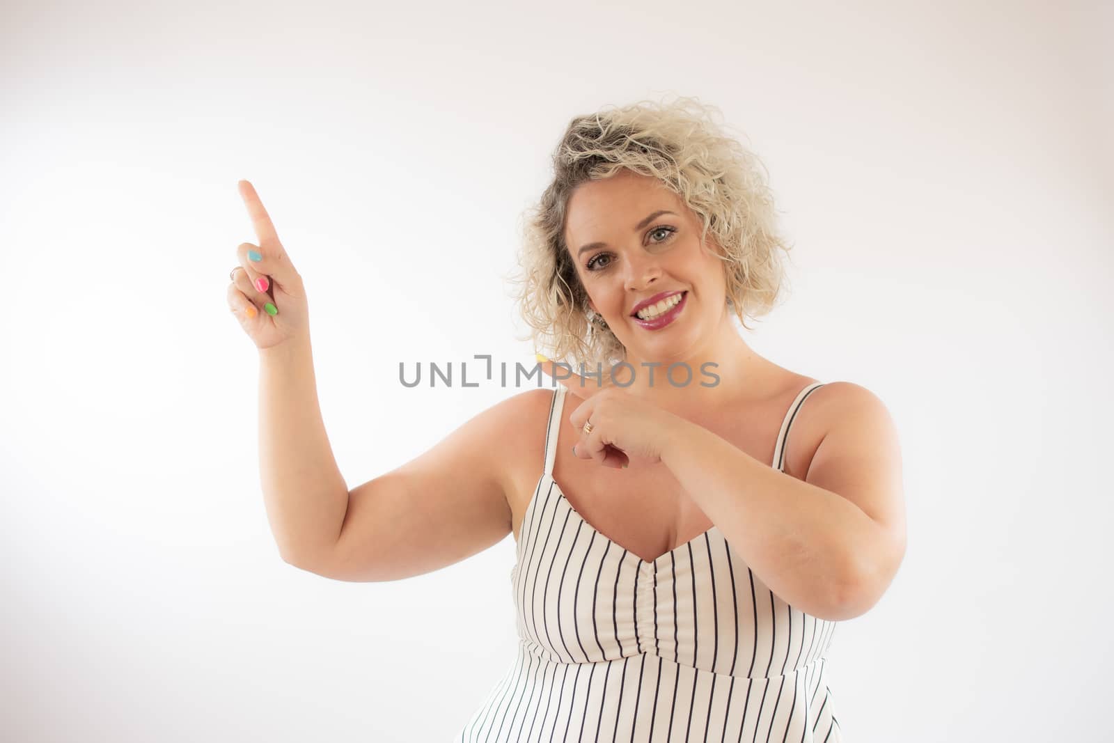 Blonde young woman pointing something with her fingers