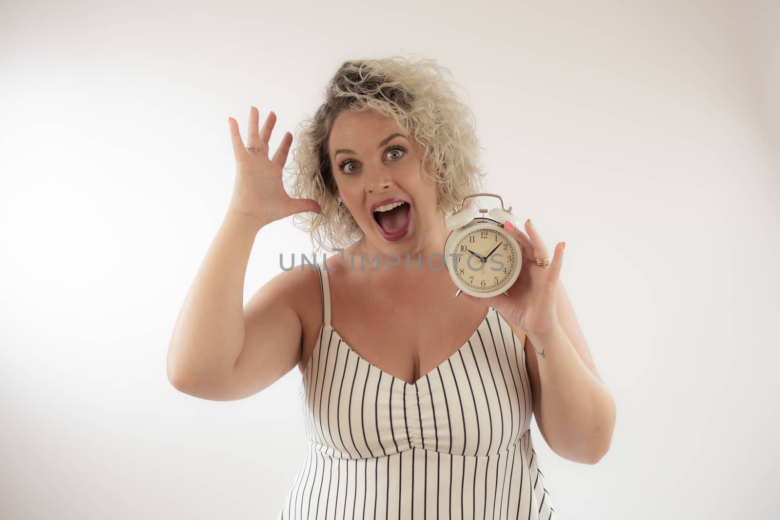 Blonde woman with a clock in her hand