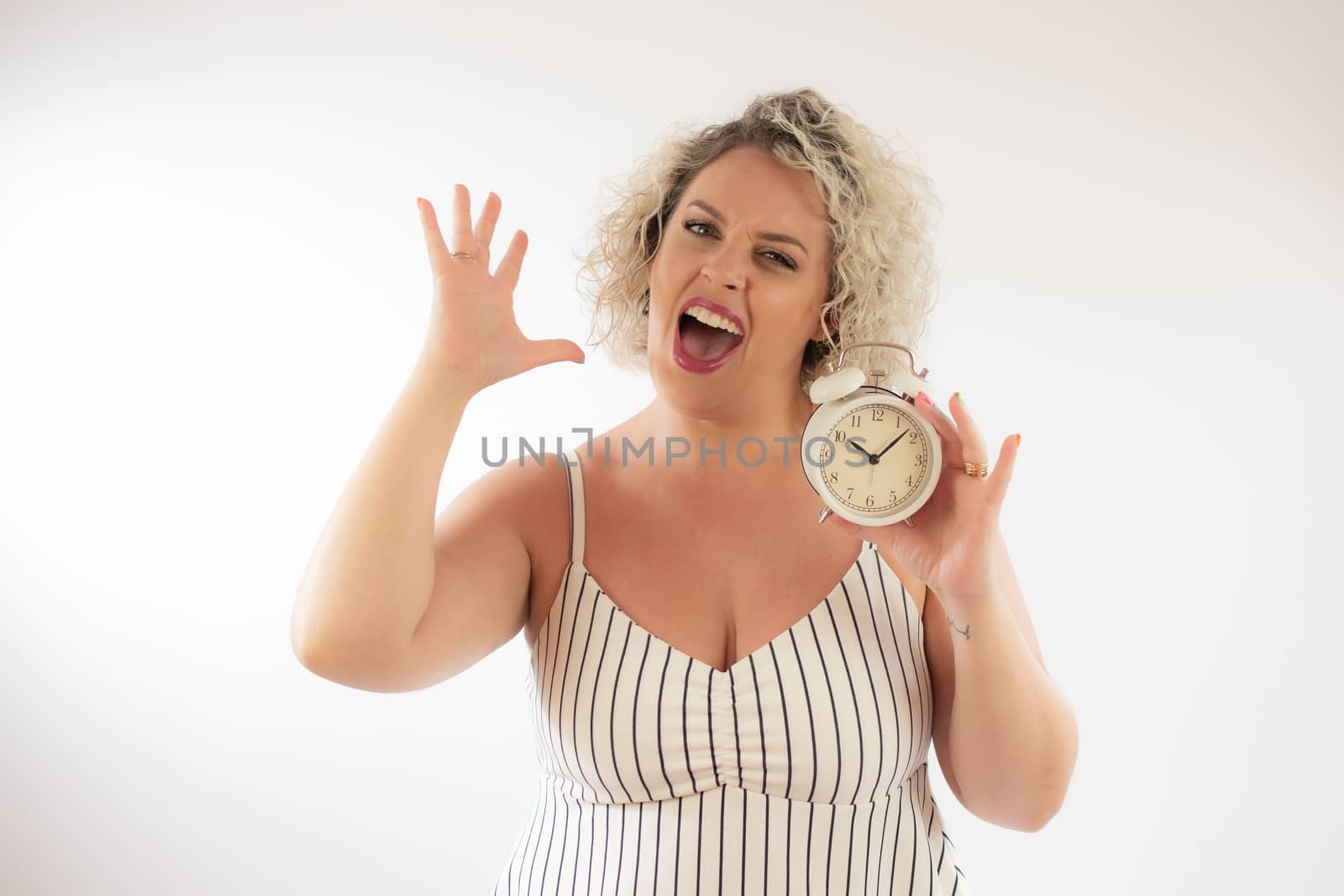Blonde woman with a clock in her hand