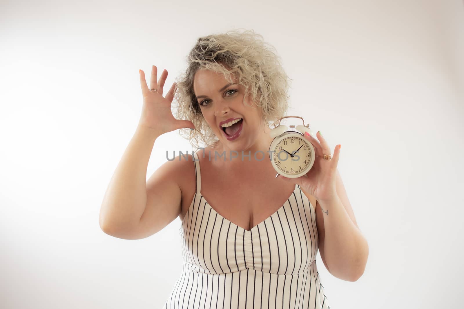 Blonde woman with a clock in her hand