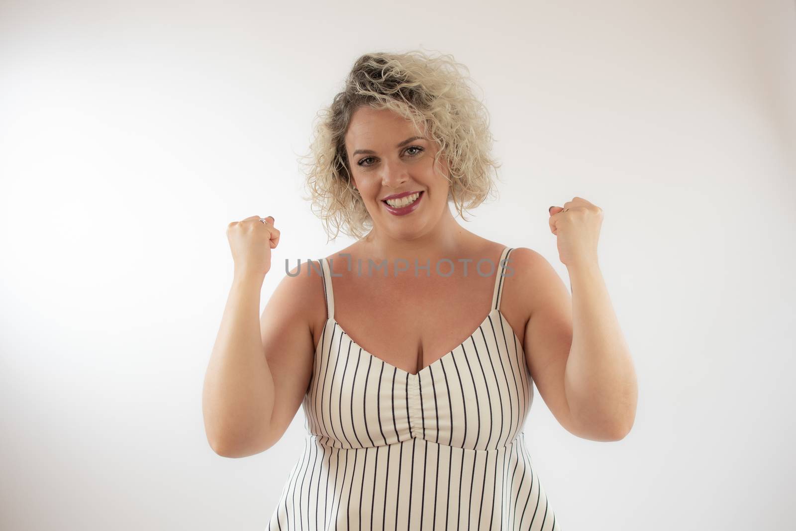 Blonde young woman making the winner gesture by lmstudio