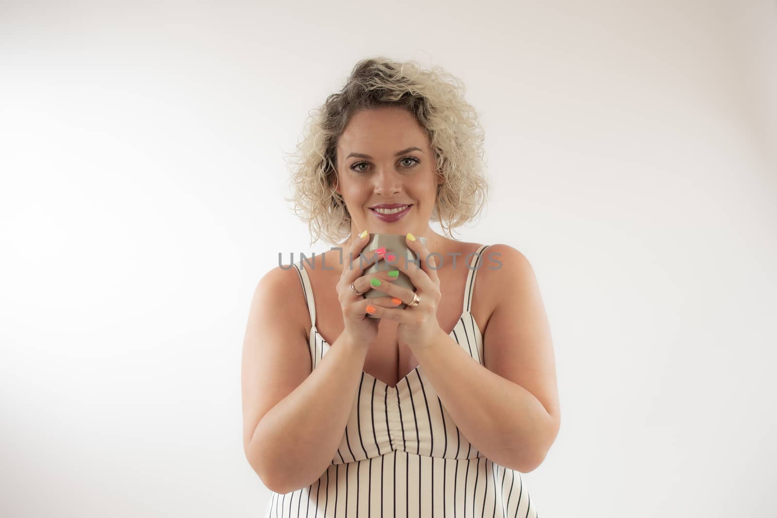 Blonde young woman drinking a cup of coffee