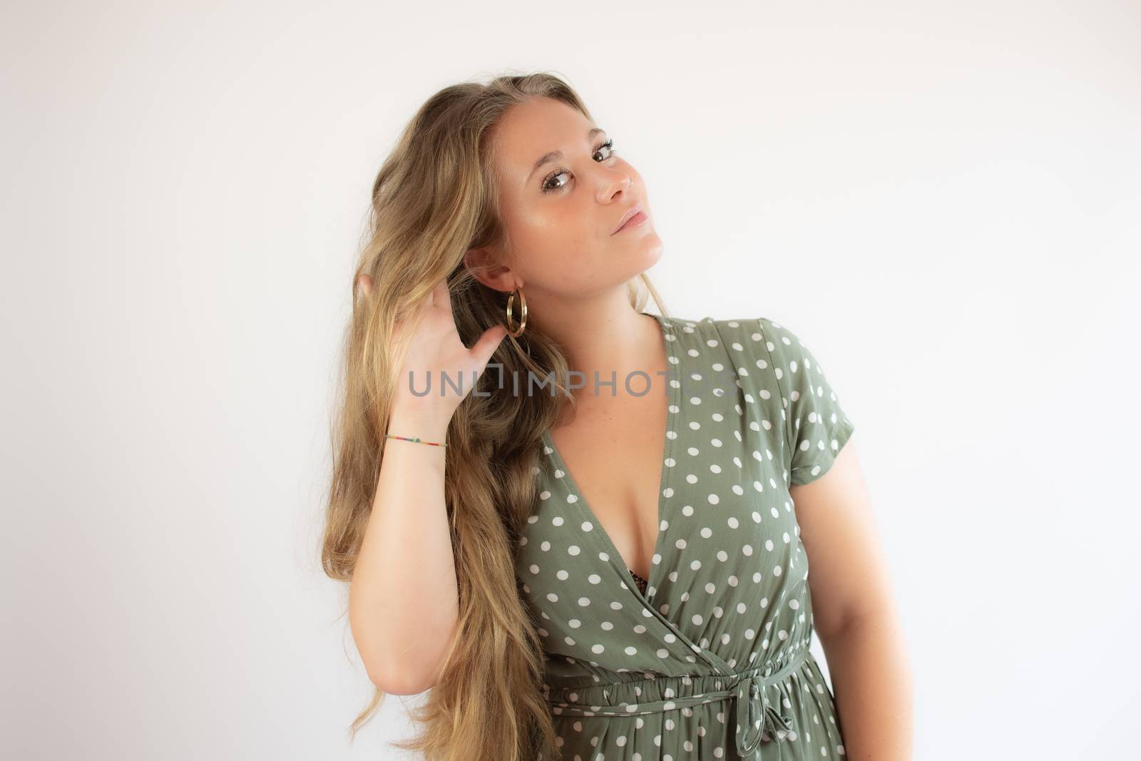 Beautiful young girl with long hair making the listening gesture