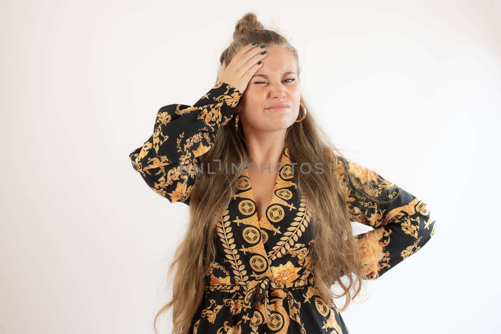 Pretty blonde girl in black gold dress thoughtful