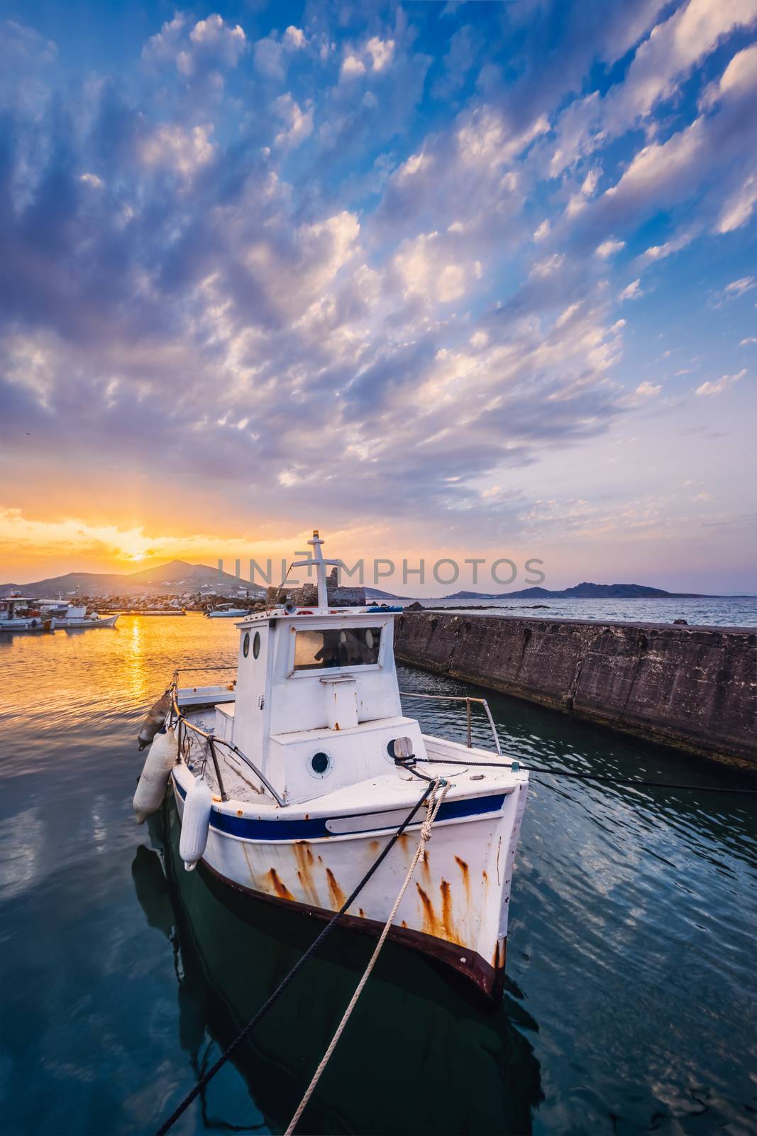 Old fishing boat in port of Naousa on sunset. Paros lsland, Greece