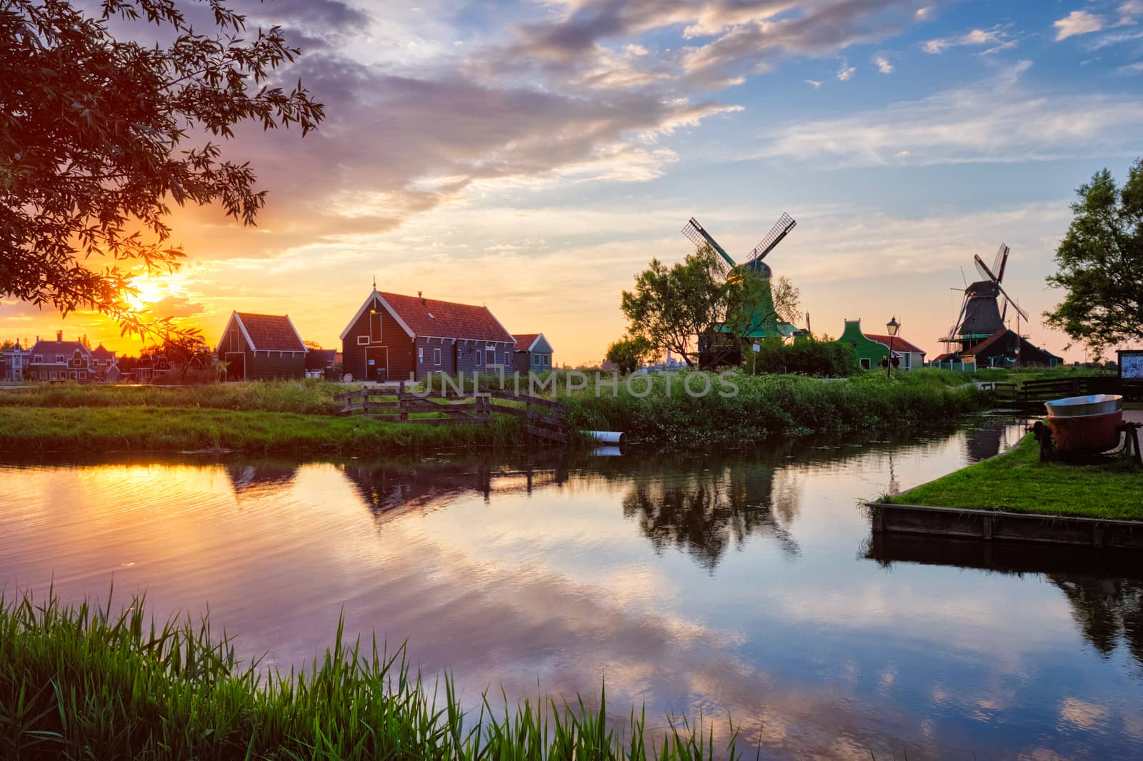 Netherlands rural scene - - windmills at famous tourist site Zaanse Schans in Holland on sunset with dramatic sky. Zaandam, Netherlands