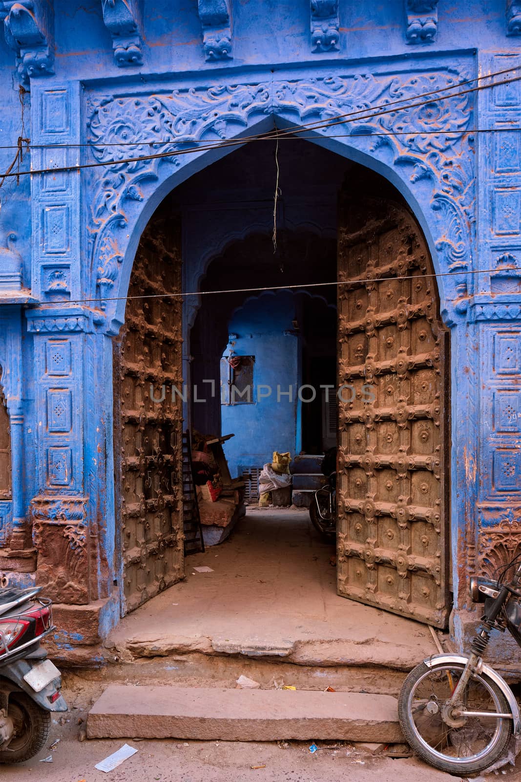 Blue house facade in streets of of Jodhpur, also known as "Blue City" due to the vivid blue-painted Brahmin houses, Jodhpur, Rajasthan, India