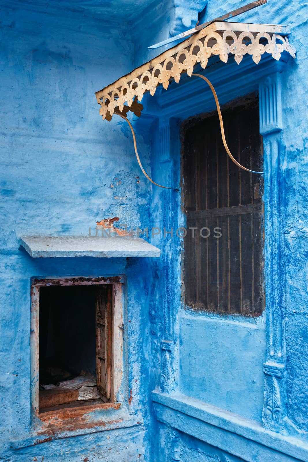 Windows in blue house facade in streets of of Jodhpur, also known as Blue City due to the vivid blue-painted Brahmin houses, Jodhpur, Rajasthan, India