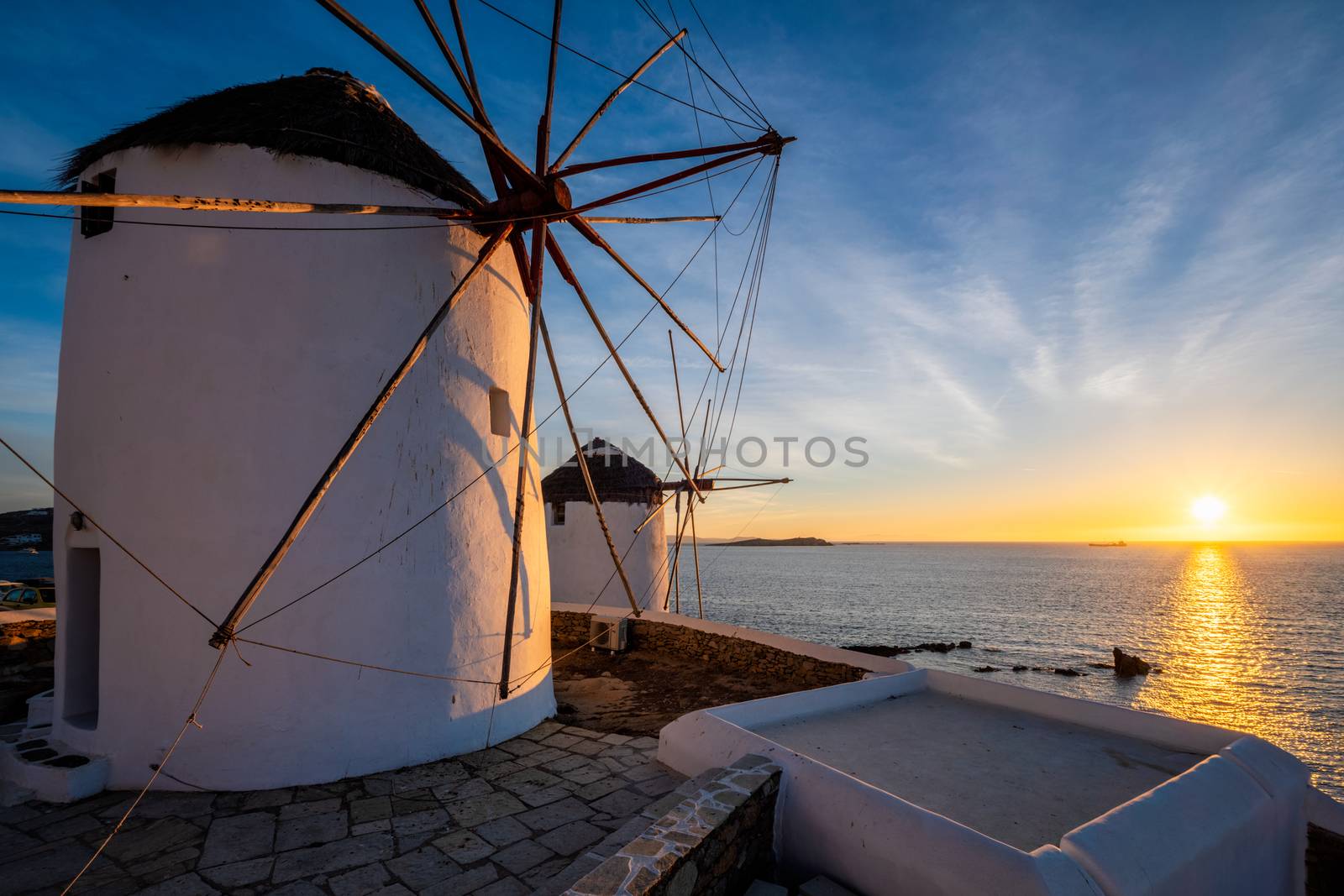 Traditional greek windmills on Mykonos island at sunrise, Cyclades, Greece by dimol
