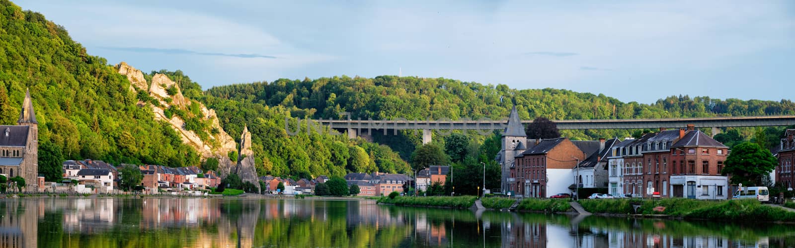 View of picturesque Dinant city over the Meuse river Dinant is a Walloon city and municipality located on the River Meuse, in the Belgian province of Namur on sunset with Bayard Rock and highway