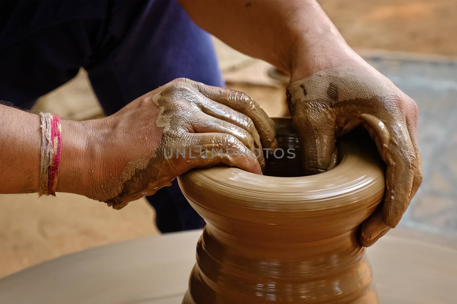 Indian potter hands at work, Shilpagram, Udaipur, Rajasthan, India by dimol