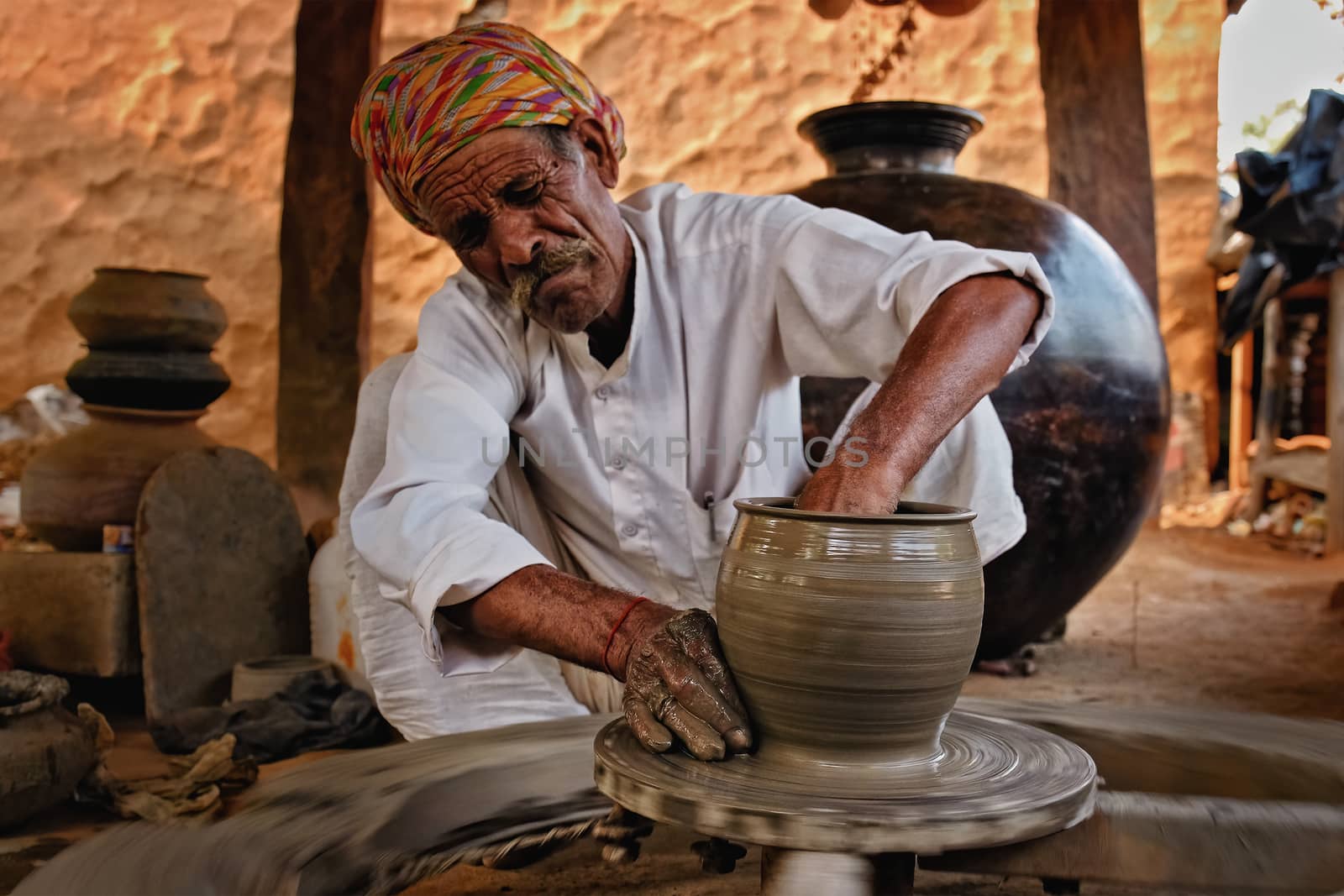 Indian potter at work. Handwork craft from Shilpagram, Udaipur, Rajasthan, India by dimol