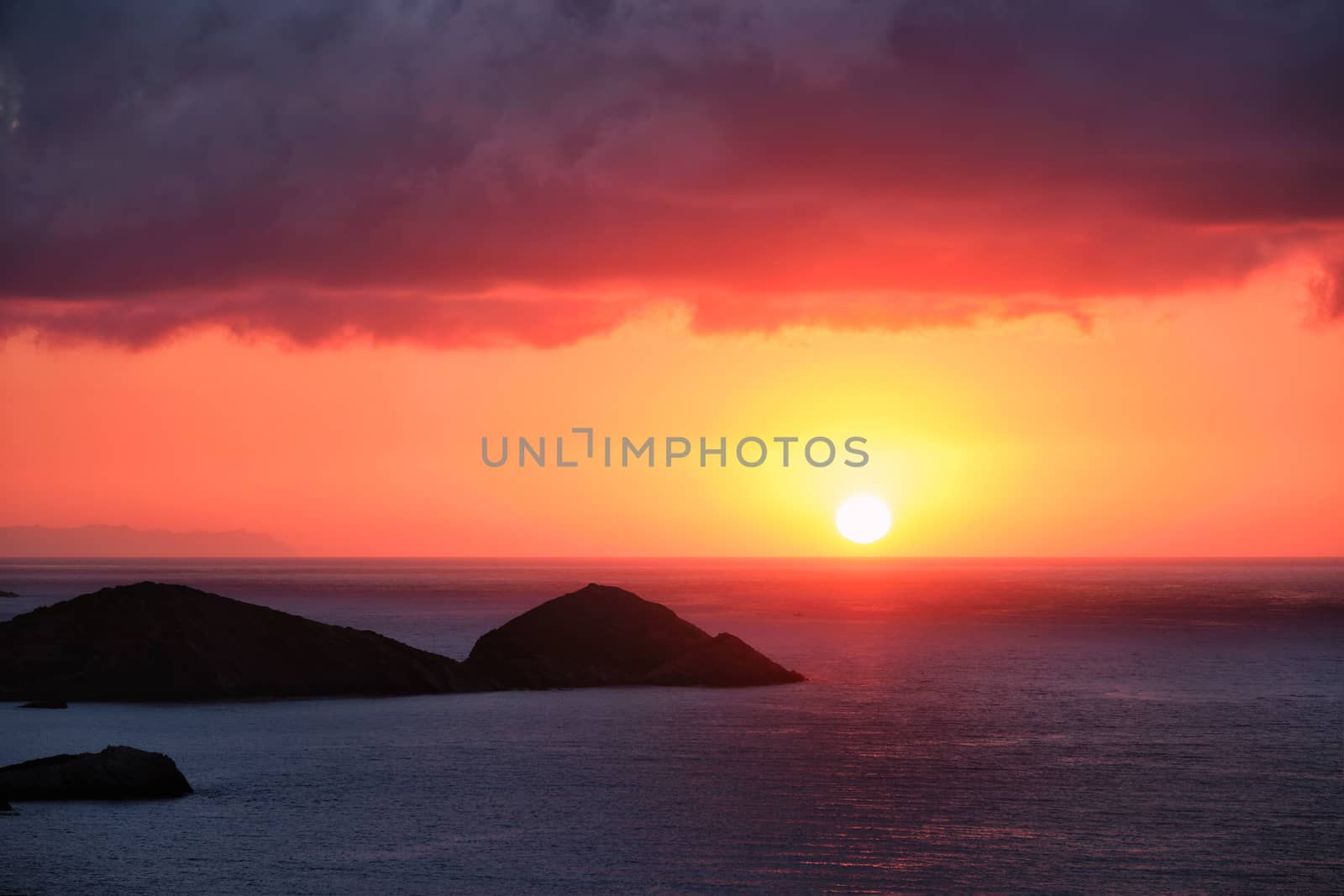 Sea sunset. Seascape sunset with island. Sun setting down in sea. Crete island, Greece