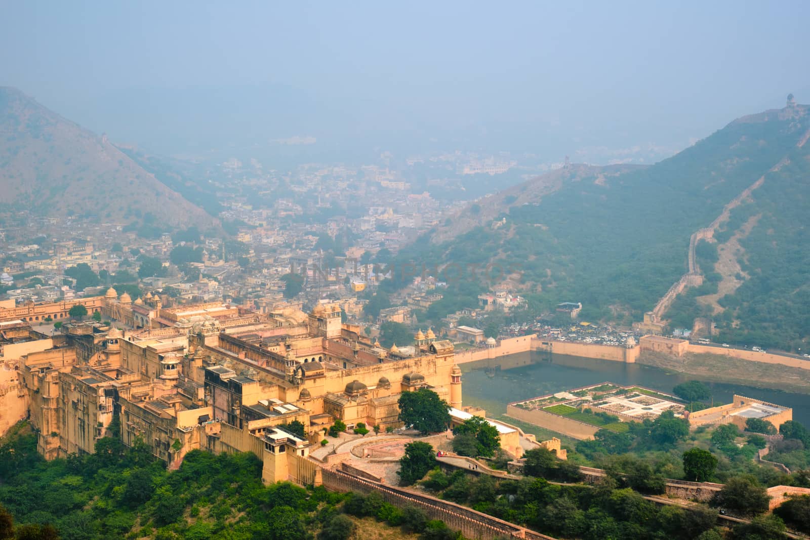 Indian travel famous tourist landmark - view of Amer (Amber) fort and Maota lake from Jaigarh Fort. Jaipur, Rajasthan, India