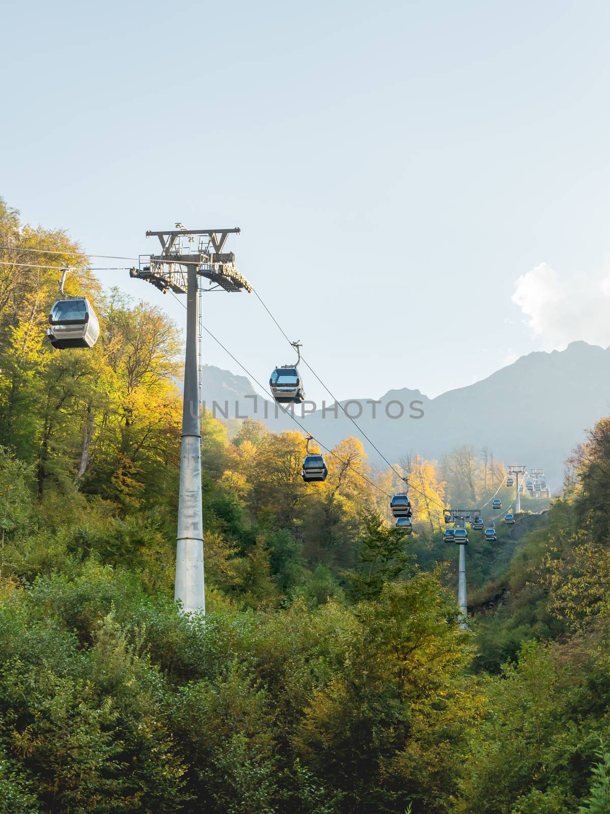 Passenger cabins move along cables of funicular. Cable road at Rosa Khutor Alpine Ski Resort. Sochi, Russia.