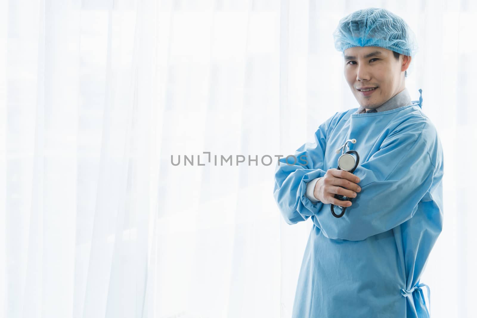 Portrait of a professional surgeon, an Asian man carrying a stethoscope operating in an emergency room. Modern medical technology and science. Concepts of care and rehabilitation in hospital patients.