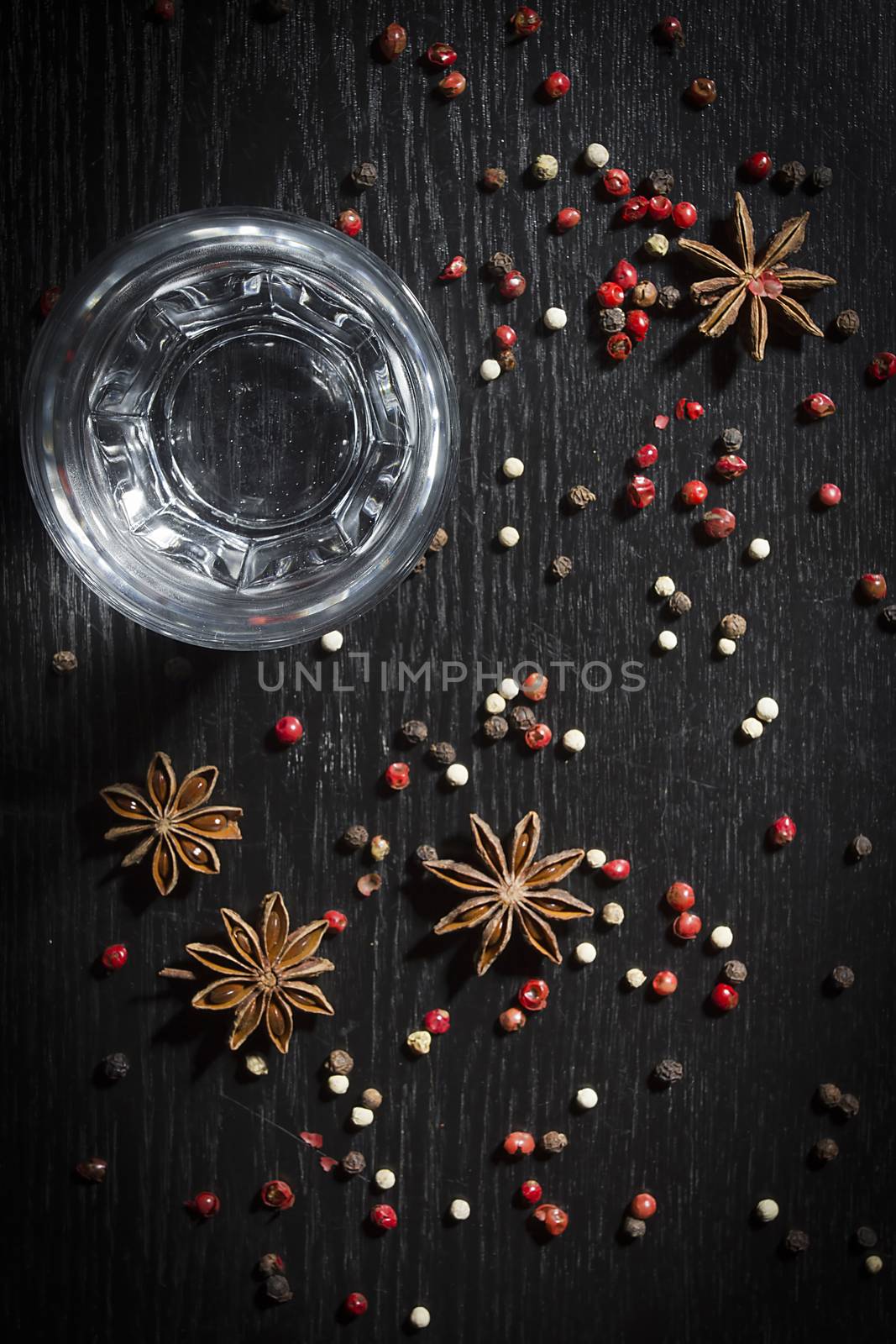 Anise vodka in a glass on a wooden surface