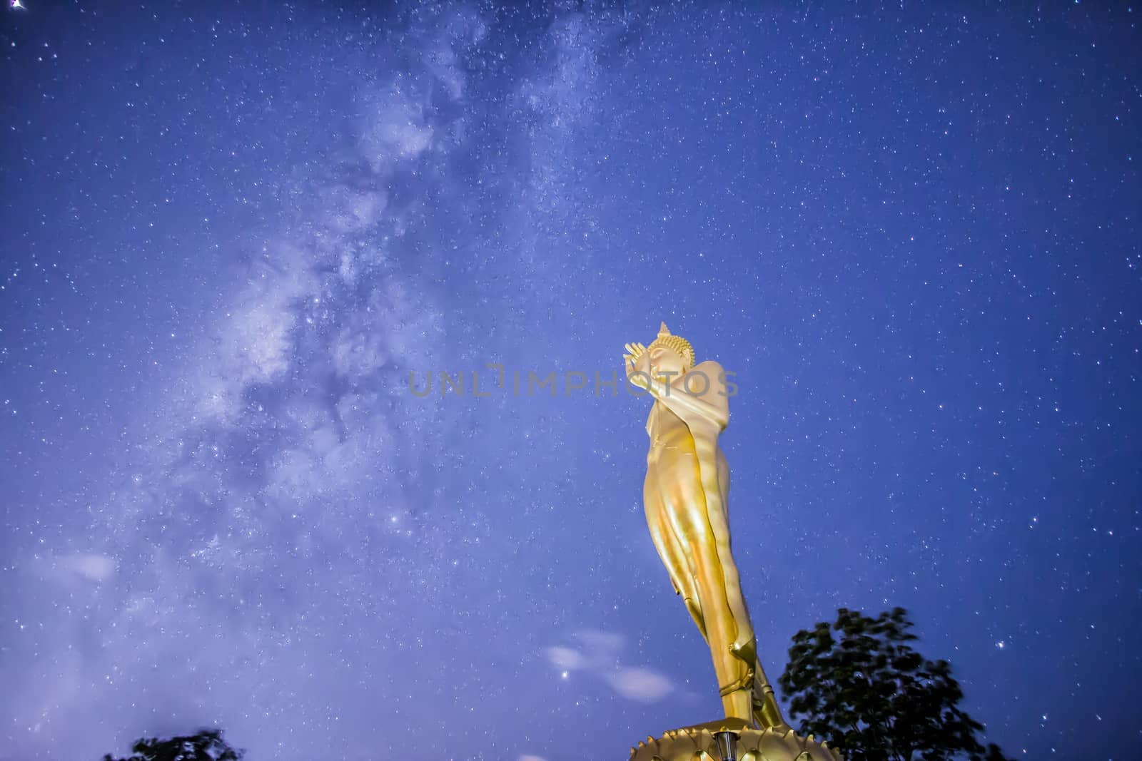 Buddha statue on the milky way background in Thailand