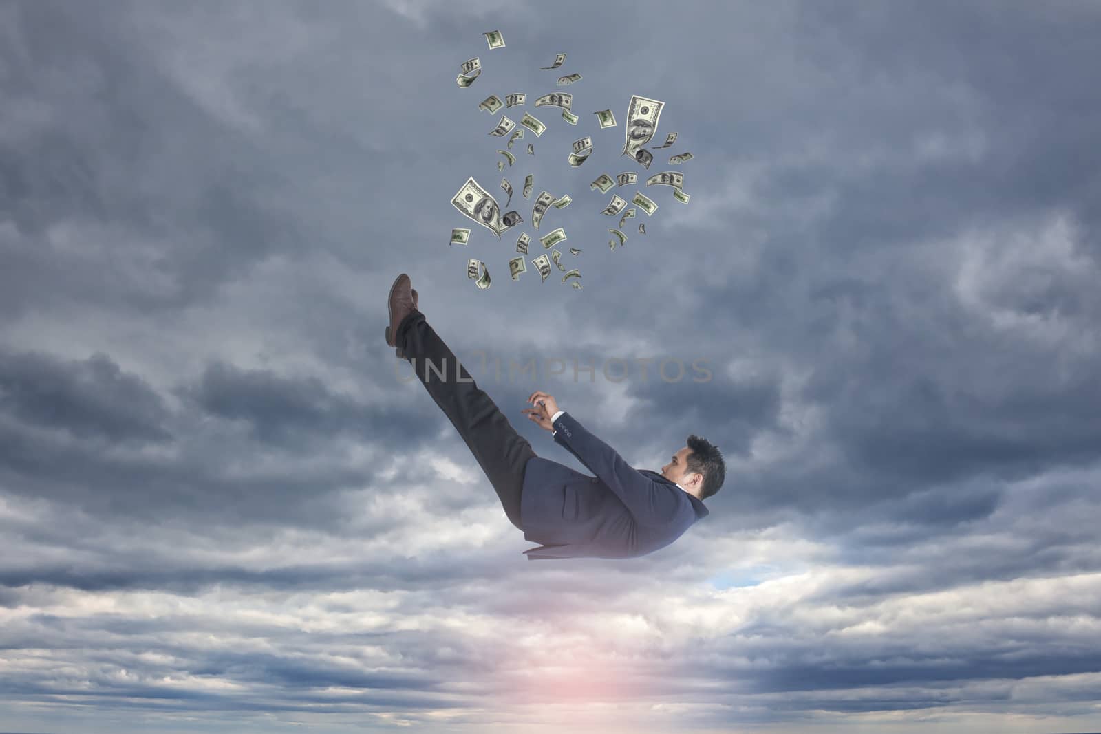 sad asian businessman falling down with money over dark sky background