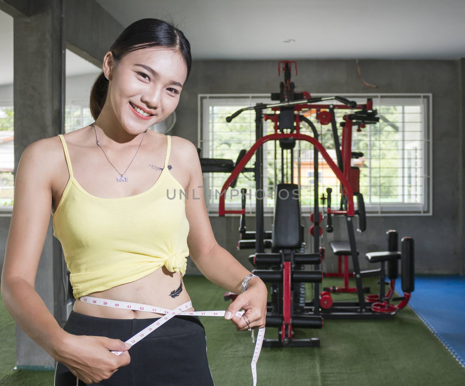 Diet fitness exercise sport sexy body happy smiling asian woman with measuring tape in fitness club, Health and body shape care concept.