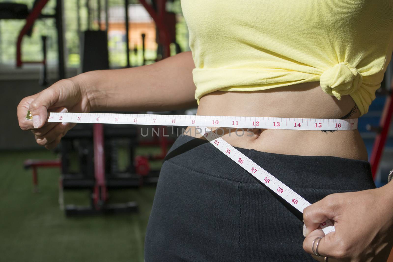 Woman measuring perfect shape of beautiful waist, healthy lifestyles concept.