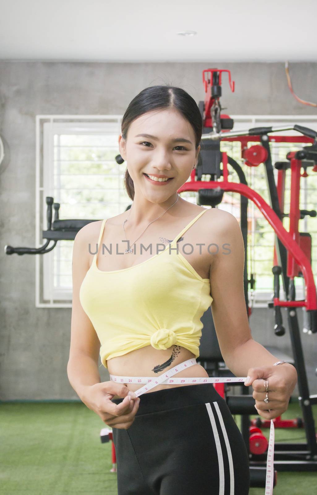 Diet fitness exercise sport sexy body happy smiling asian woman with measuring tape in fitness club, Health and body shape care concept.